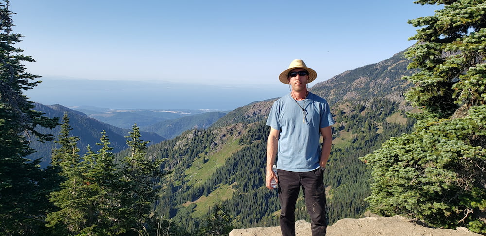 Adam Hoek outdoors near a river in the Pacific Northwest